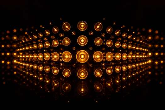 A symmetrical pattern of warm glowing lights set against a dark background, showcasing a creative light design.