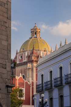 Capture of a historic building with a dome in Puebla, showcasing intricate architectural elegance.