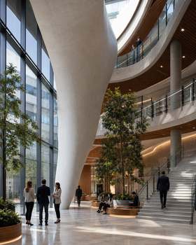 Spacious modern interior with architectural elements and people interacting.